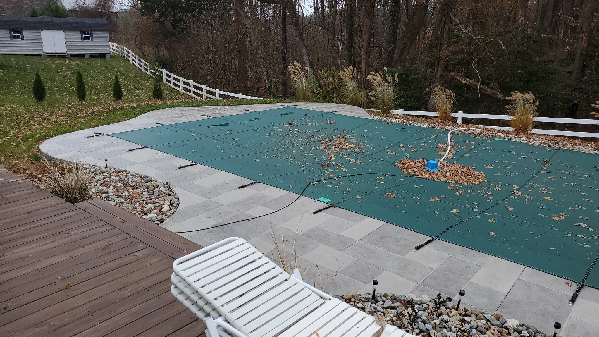 Safety cover anchored to pool deck